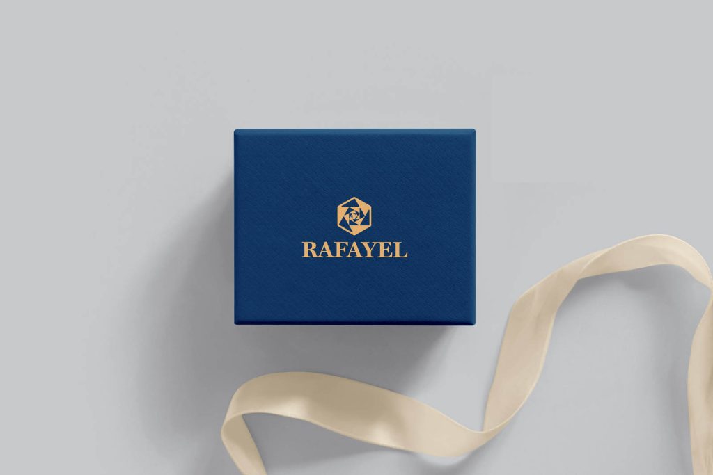 Modern logo design example in situ on a navy blue jewellery gift box.