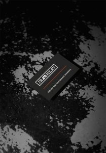 A dark business card with logo on a scuffed oil drum. An example of industrial logo design Swindon engineer JR heat can use to stand out from the crowd.